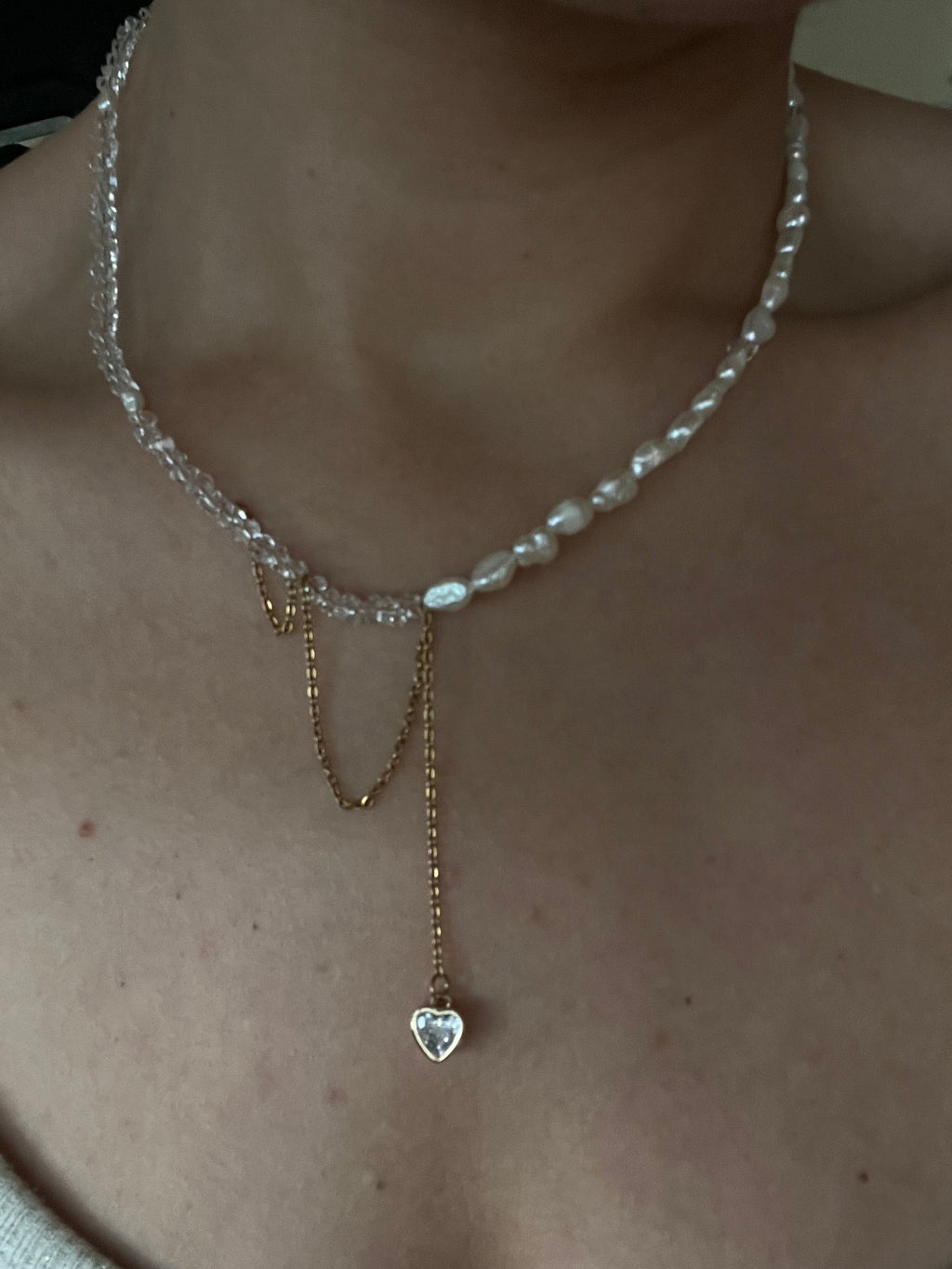 Model wearing the Duality Necklace by Sirena Jewelry, showing the elegant contrast between pearls and gold chain details.