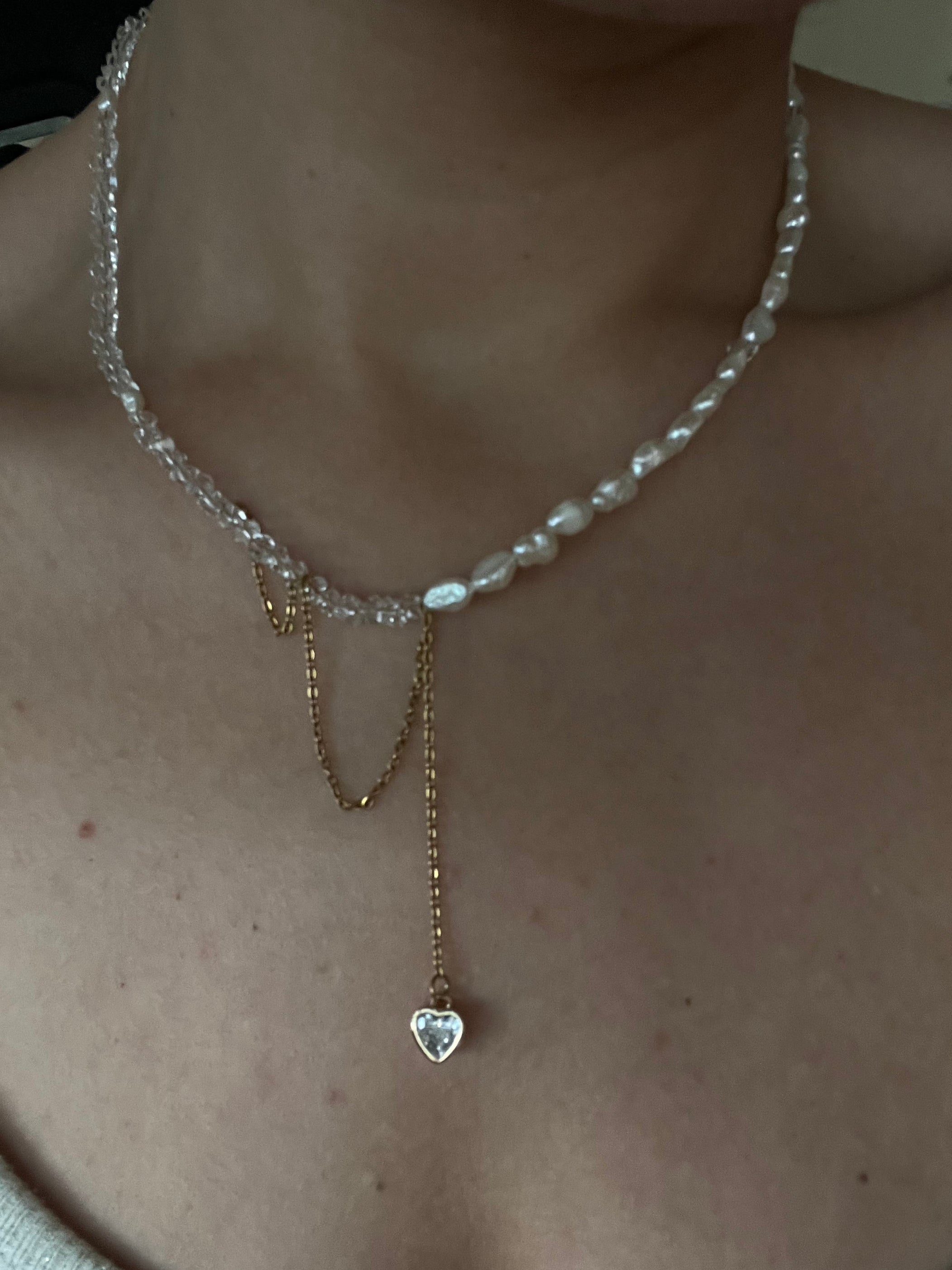 Model wearing the Duality Necklace by Sirena Jewelry, showing the elegant contrast between pearls and gold chain details.